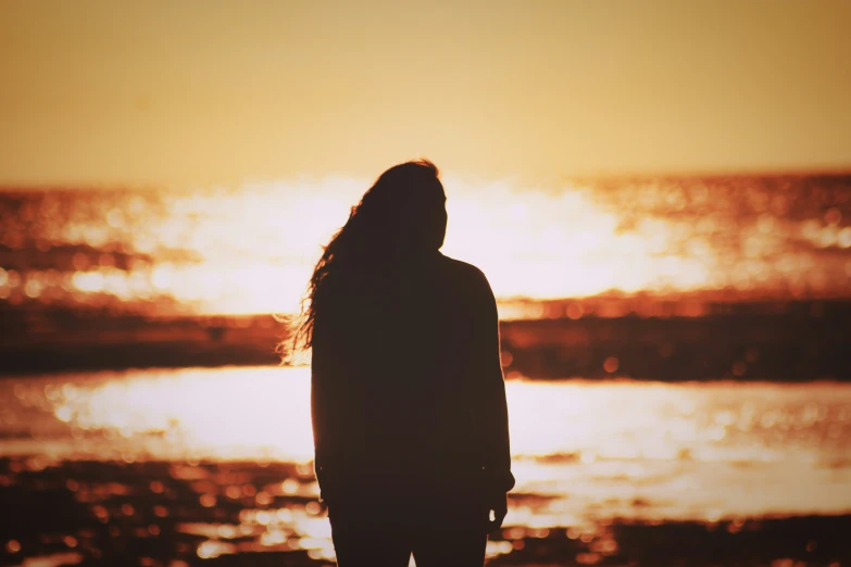 a person standing in front of a body of water