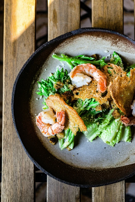 shrimp, lettuce and other toppings on a plate