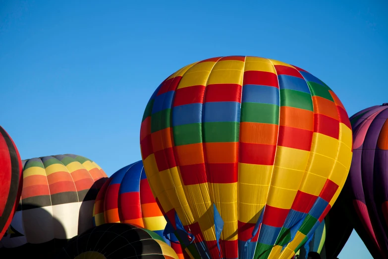 some colorful  air balloons are flying through the sky