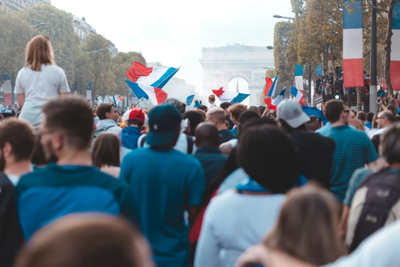 a crowd is gathered in front of a white building