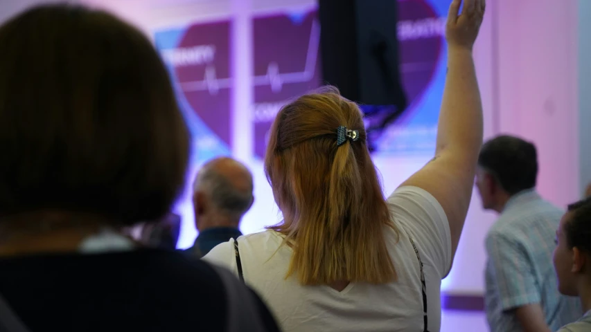 a woman raises her hand up in the air