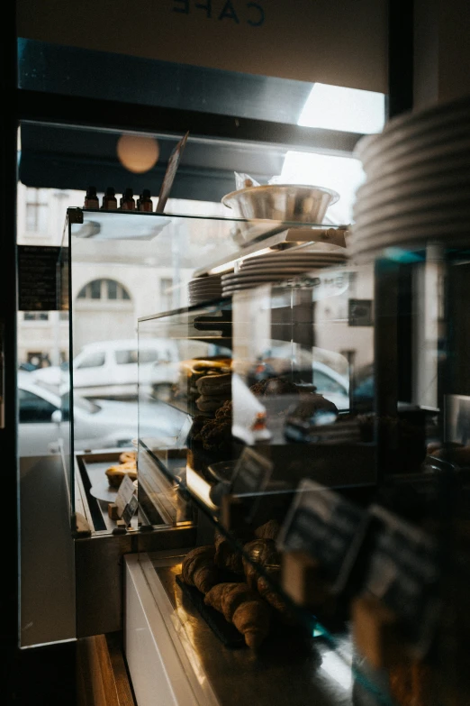 a window at a cafe displaying breads and pastries