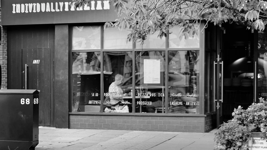 the shopfront of an eatery and other restaurant in a downtown area