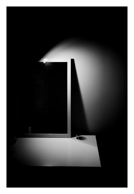 a mirror and some lights on a black table