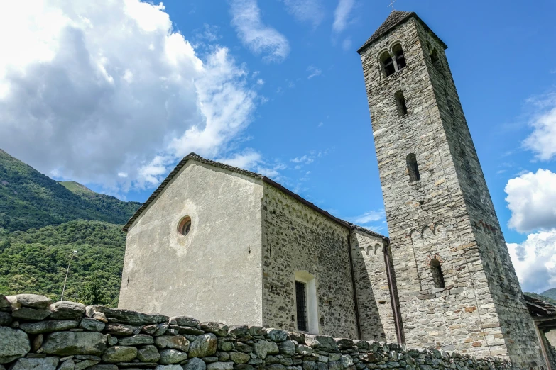 a church with stone architecture and a clock tower