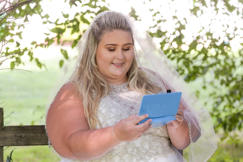 a woman in a wedding dress looking at soing