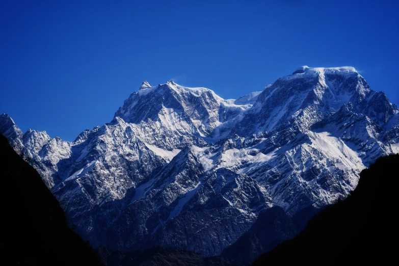 the side of a snowy mountain with a sky background