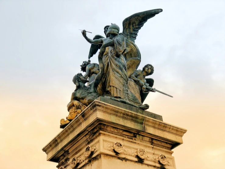 there is a large statue of an angel on the top of a building