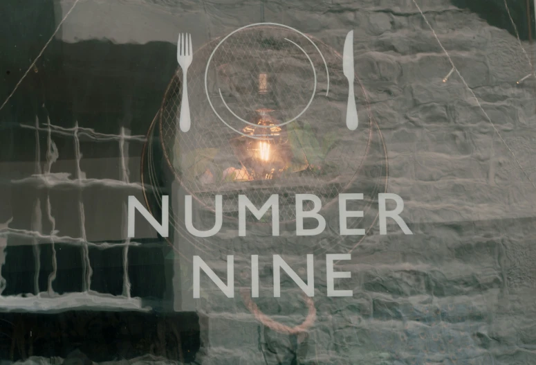 the words number nine in the reflection of a restaurant door