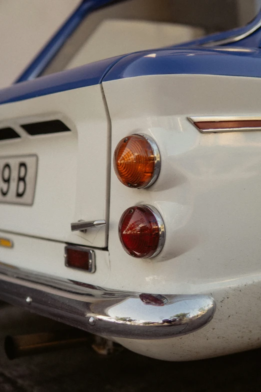 the front end of an old car with a license plate