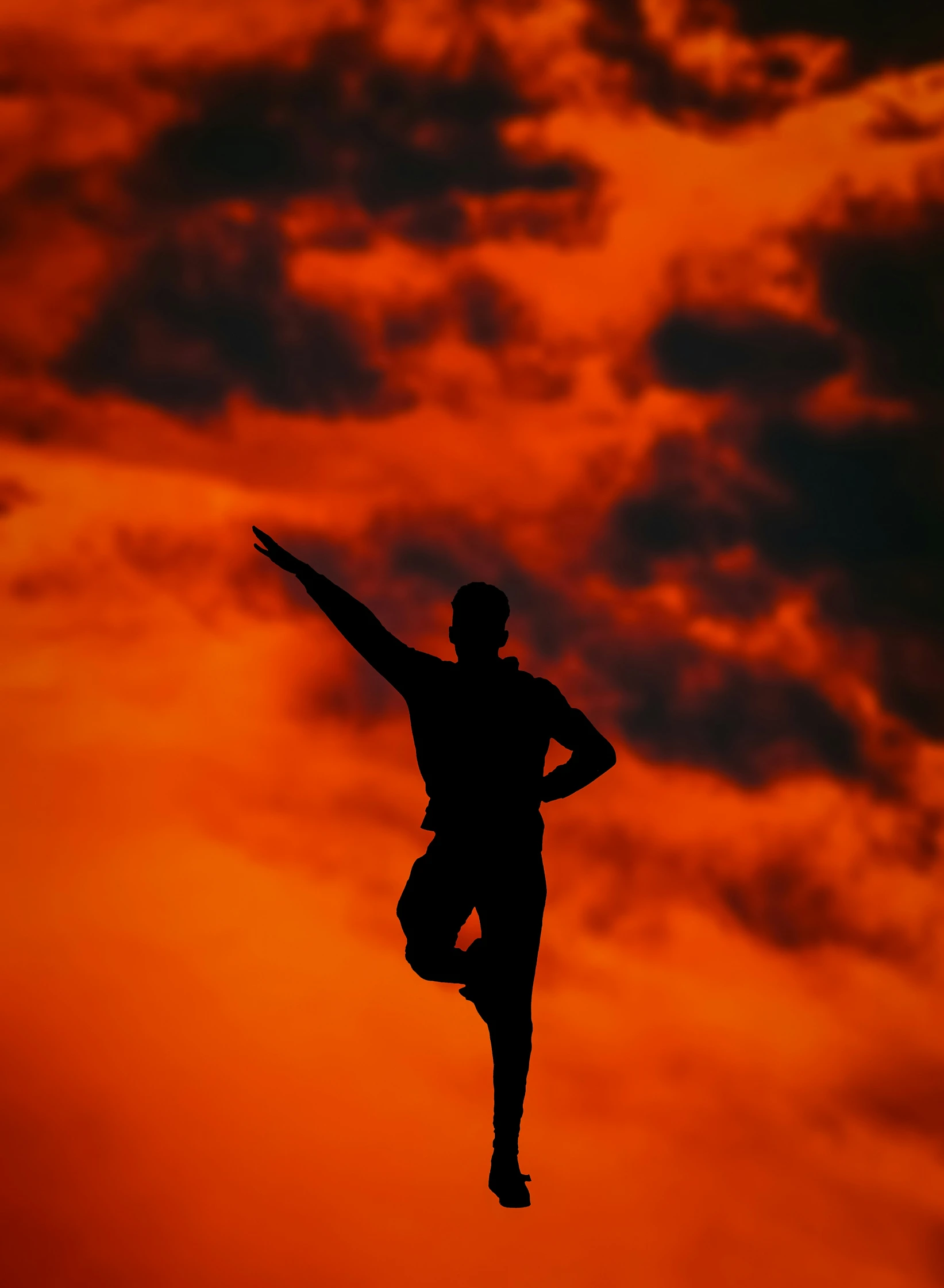 a man jumping high with his arms outstretched in the air