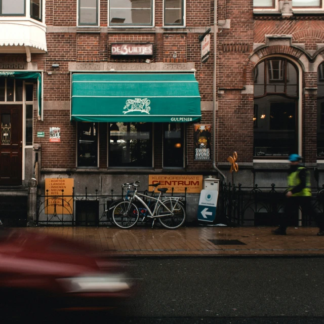 two bikes parked outside of a green canopy