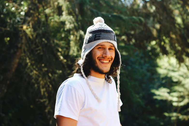 a man in white is wearing a grey and white hat