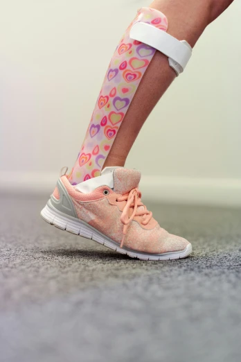 a close up of a person wearing pink athletic shoes
