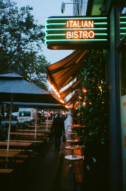 a restaurant sign lit up at night outside