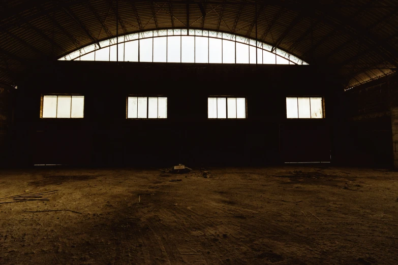 an empty warehouse is shown at night with windows