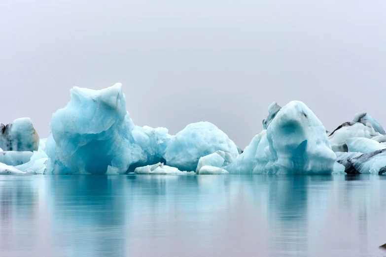 blue ice floats in a body of water