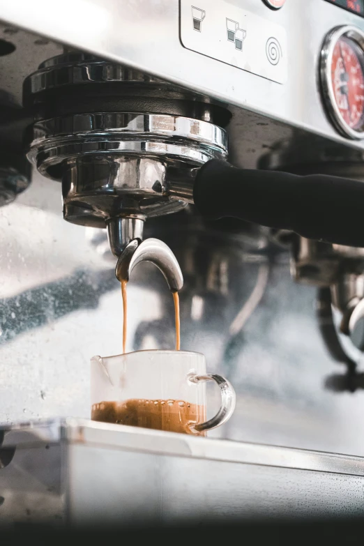 an espresso machine is being filled with liquid