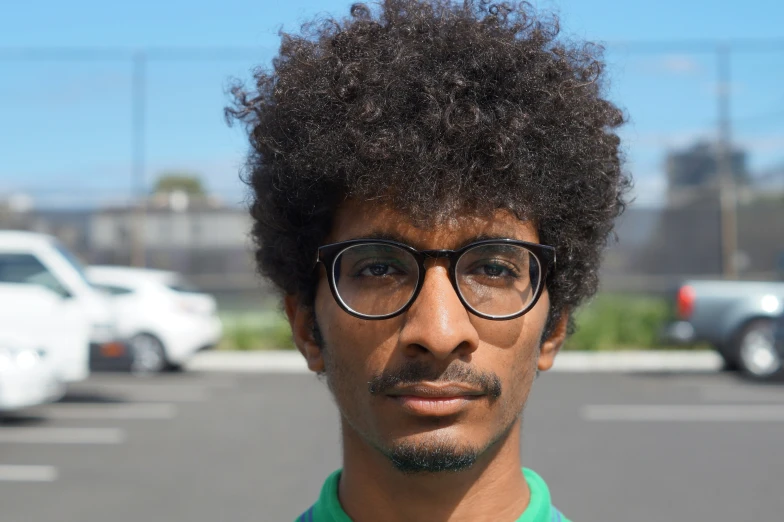 a man with a beard and glasses on