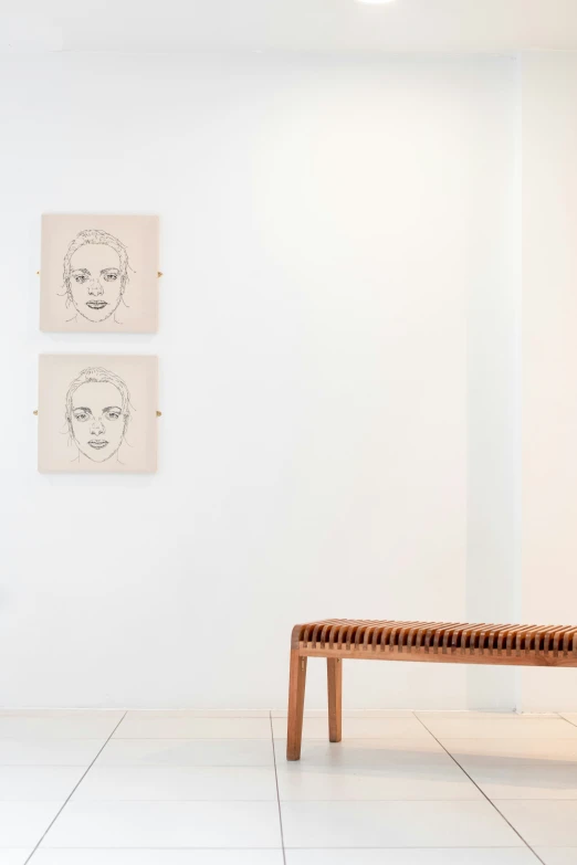 two paintings and a bench in a room