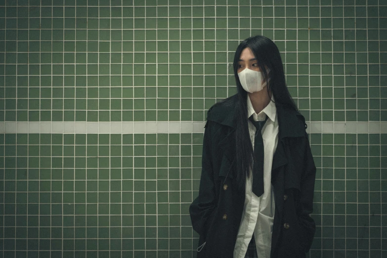 a man in a suit and tie with face mask