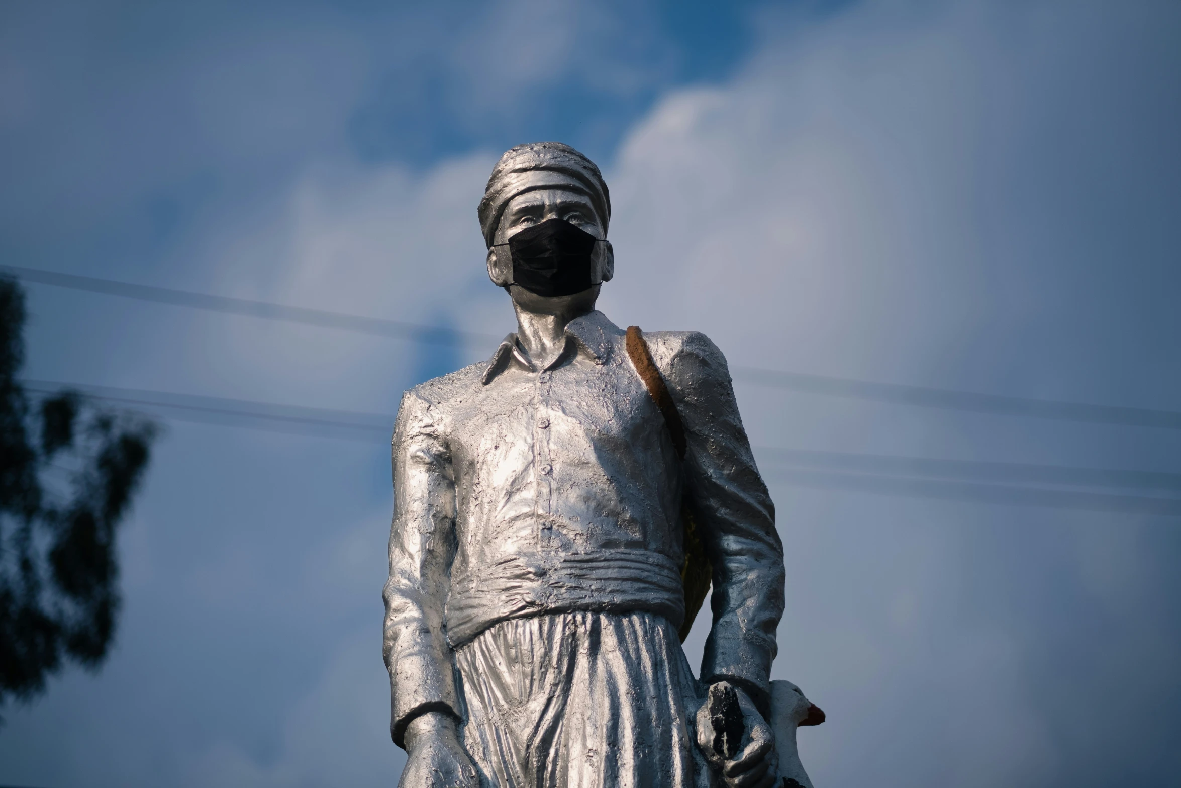 the statue is dressed in a white cloth