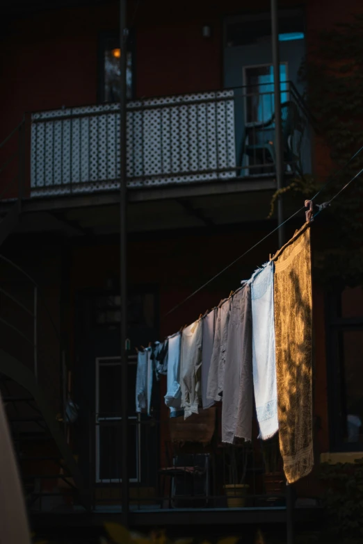 a laundry line with folded white towels and brown chair