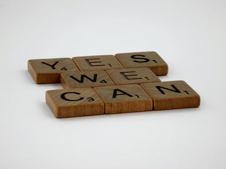 four tiles spelling yes and the word why, can are they spelled with scrabbles?