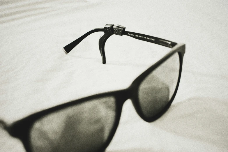 a pair of glasses on a white surface