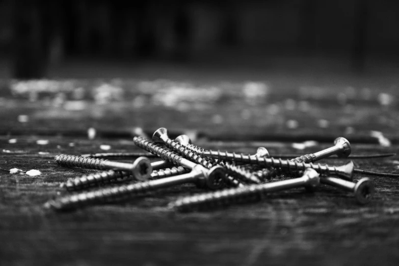 several small screws are sitting on a table