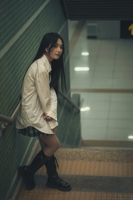 a woman wearing boots posing for a po