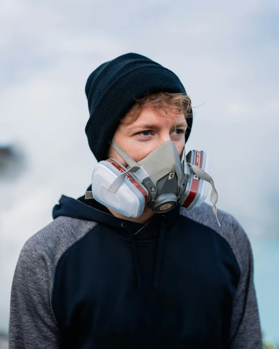 a man wearing a gas mask during the daytime