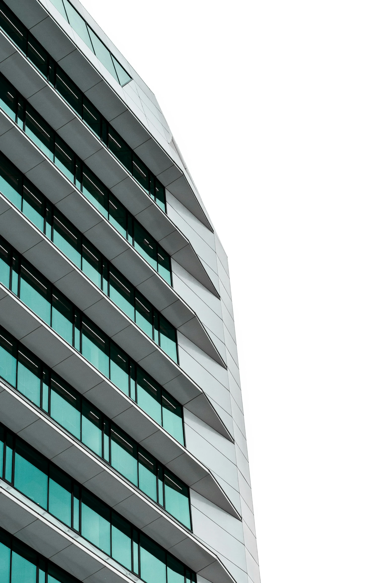 the corner of a tall office building with many windows