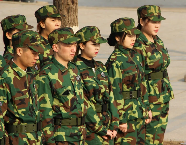several young women in camouflage uniforms looking forward