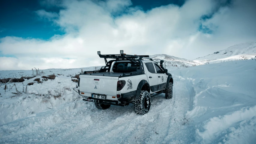 a truck is on the snow covered mountain side