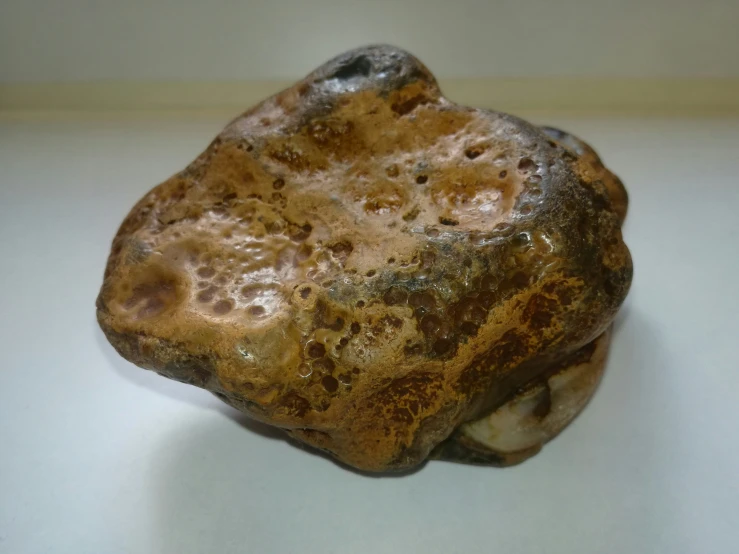 a close up of a stone with brown and white stains