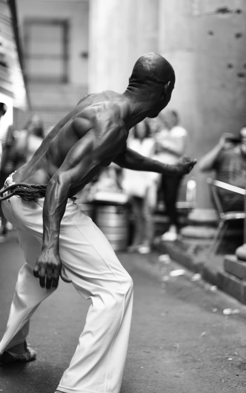 a man stretching in the middle of the street