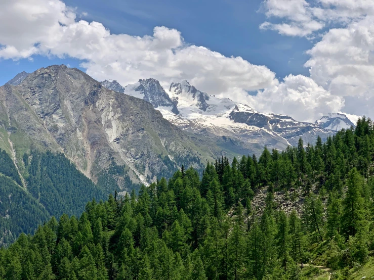 a scenic po looking at mountains, trees and a sky