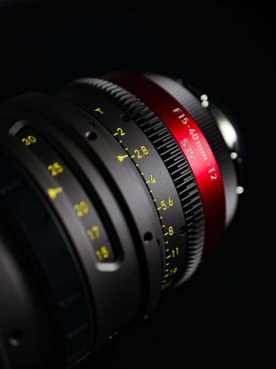 an old lens with focus gear and red light on the lens