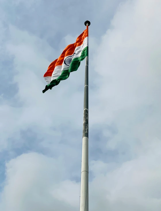 there is a very large indian flag on the pole