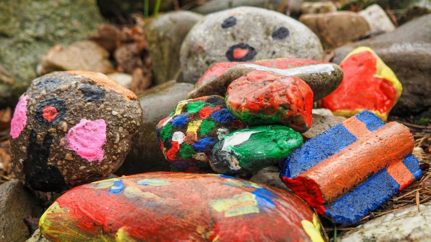 colorful rocks that are sitting on the ground