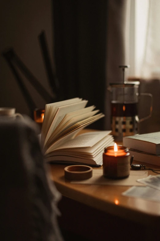 the candles are next to an open book