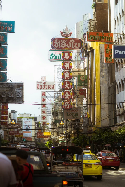 a busy city street filled with neon signs and traffic