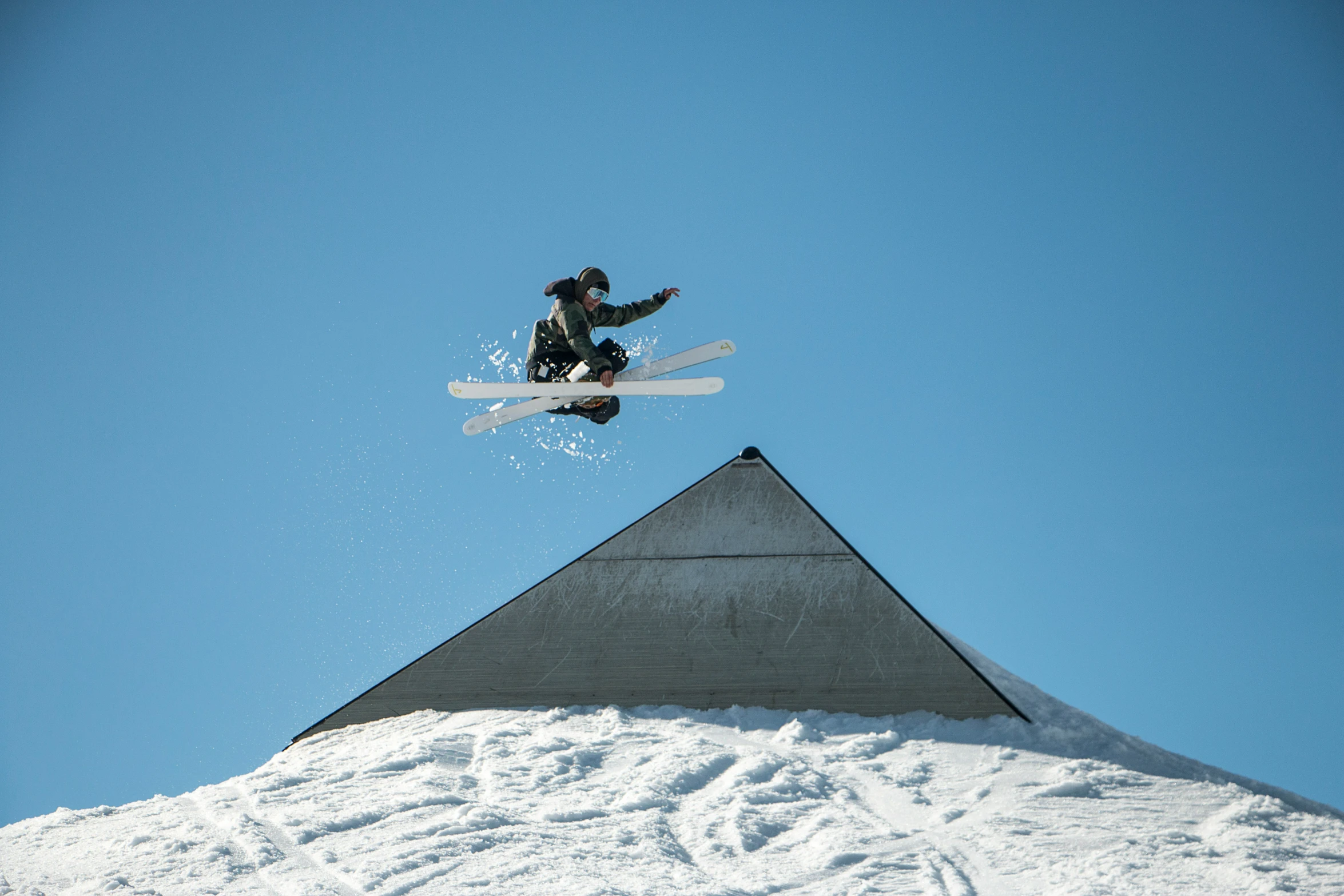 an skier jumps into the air while airborne