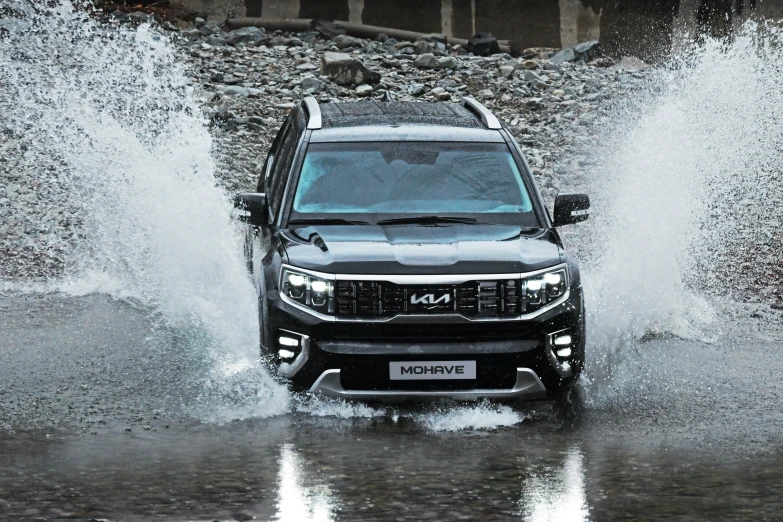 a suv driving through a lot of water on its way