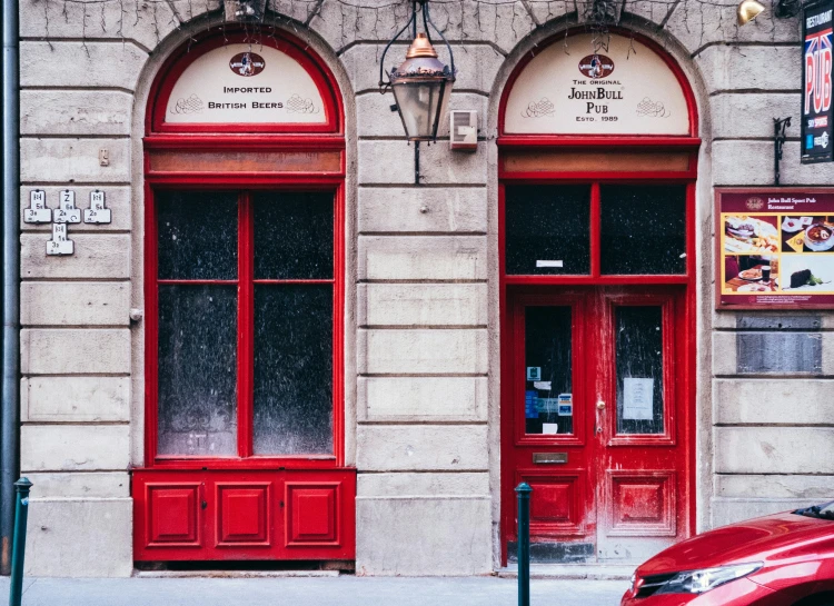 a couple of doors with red trim on a building