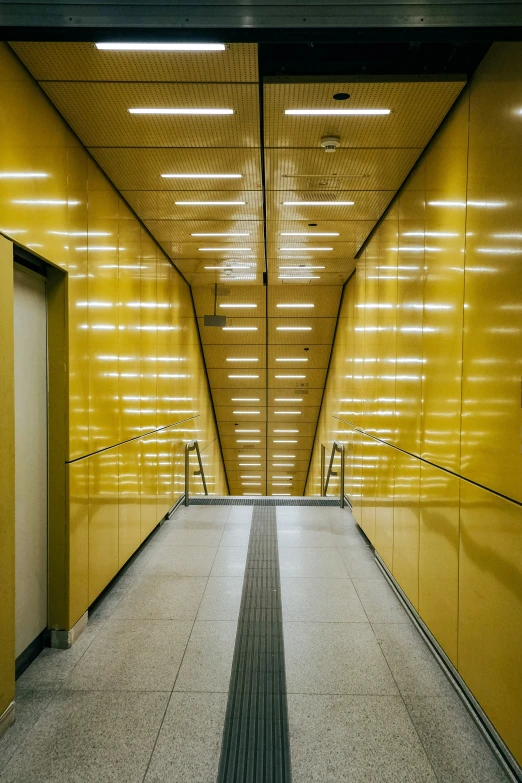 the walkway is lined with yellow wall panels