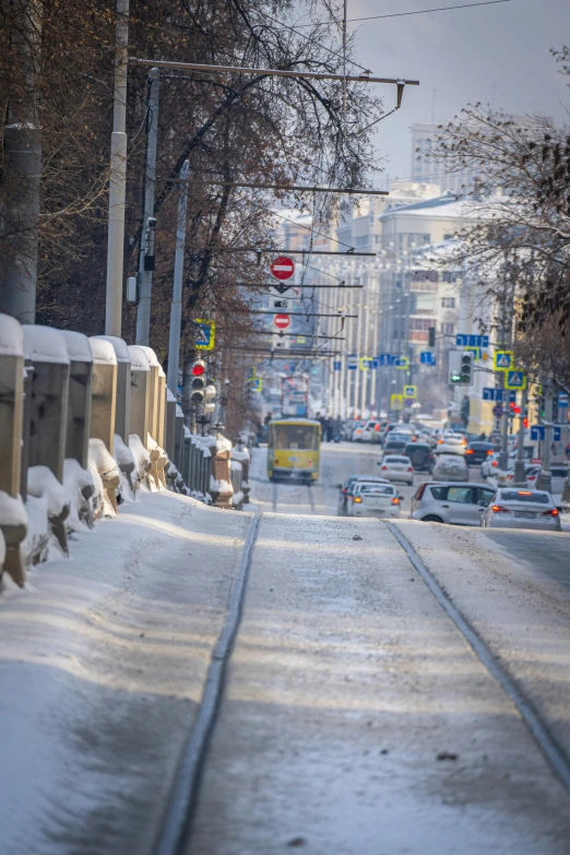 cars moving through the city covered in snow