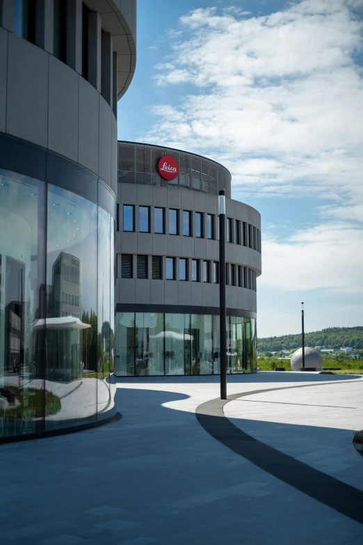 the front of a building with a circular glass and metal entrance