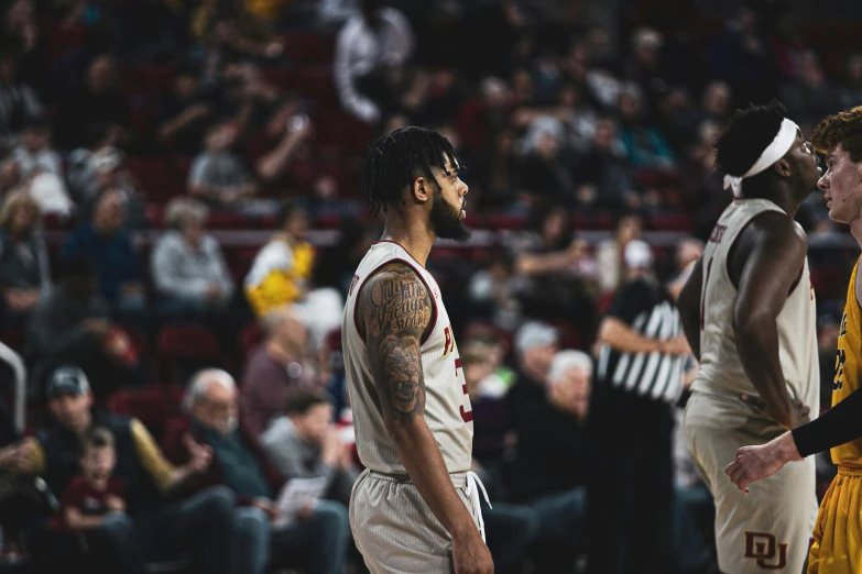 two men who are standing up during a basketball game